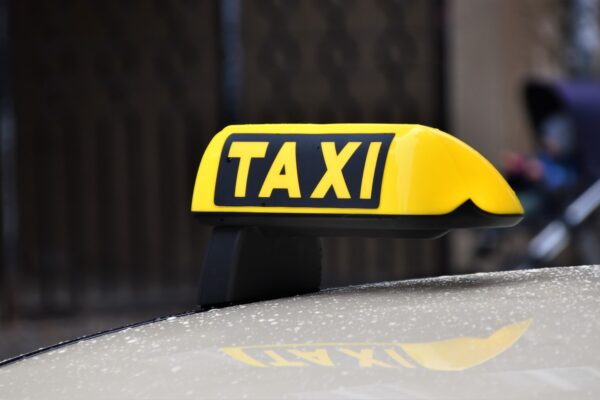 yellow and black taxi sign